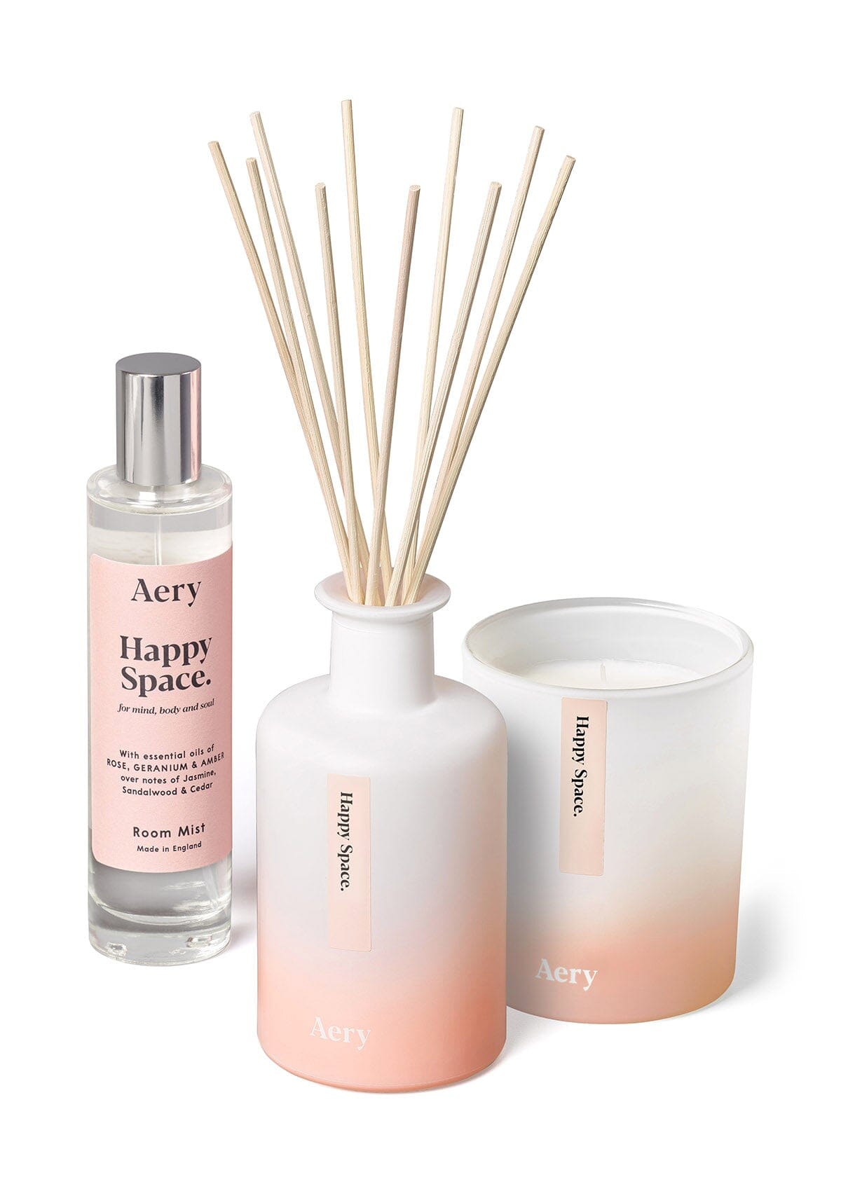 Pink happy space bundle of diffuser candle and room mist by aery displayed on white background 