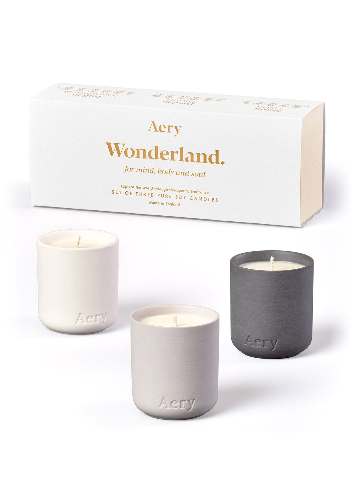 White Wonderland candle set of three displayed next to product packaging by Aery on white background 