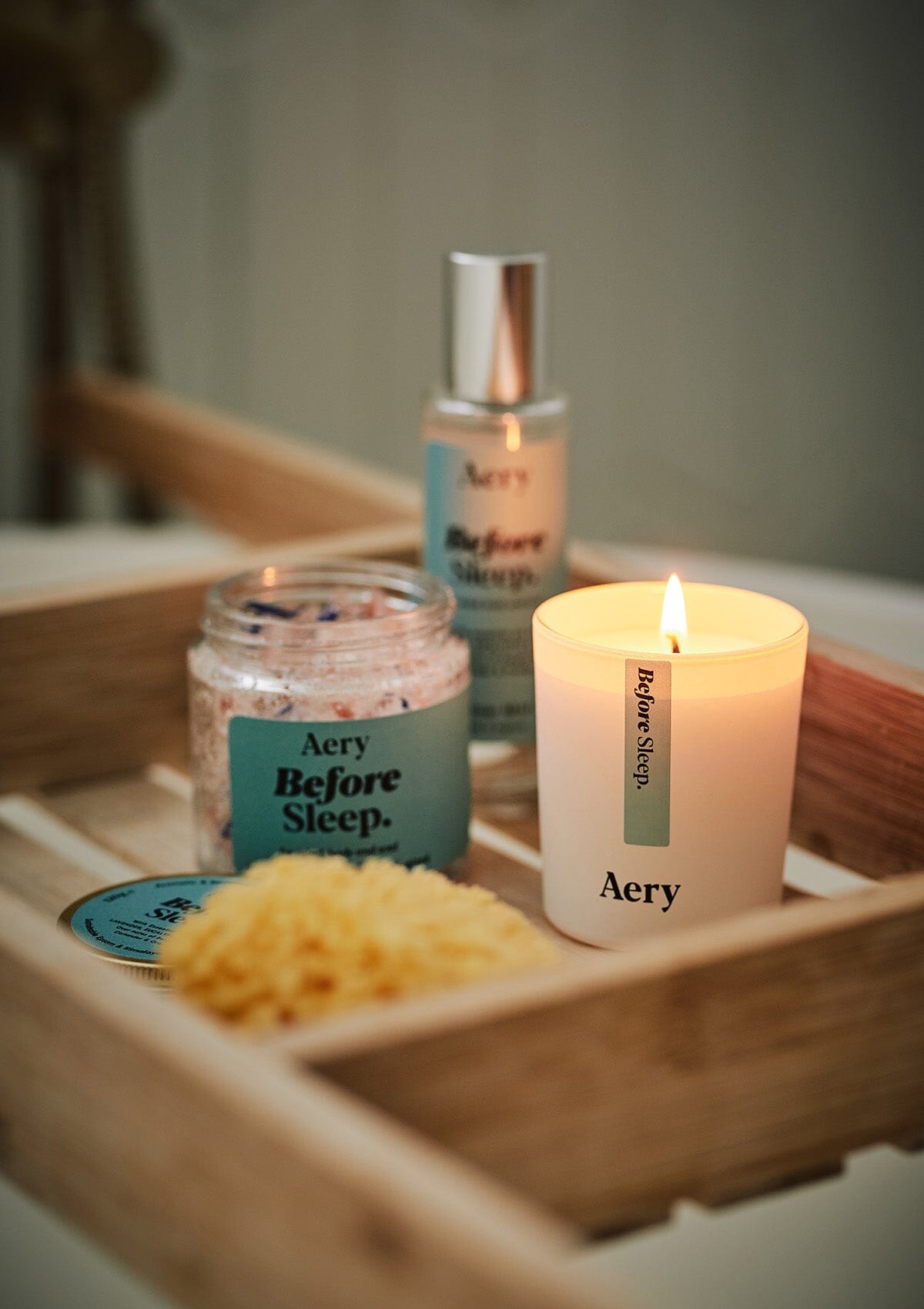 Blue Before Sleep mini bath salts jar by Aery displayed with Before sleep candle and pillow mist on wooden bath tray 