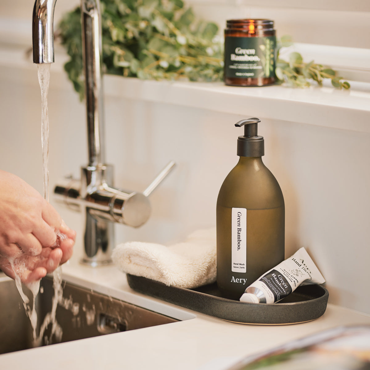 kitchen sink setting with aery living green bamboo hand wash, hand cream and scented candle