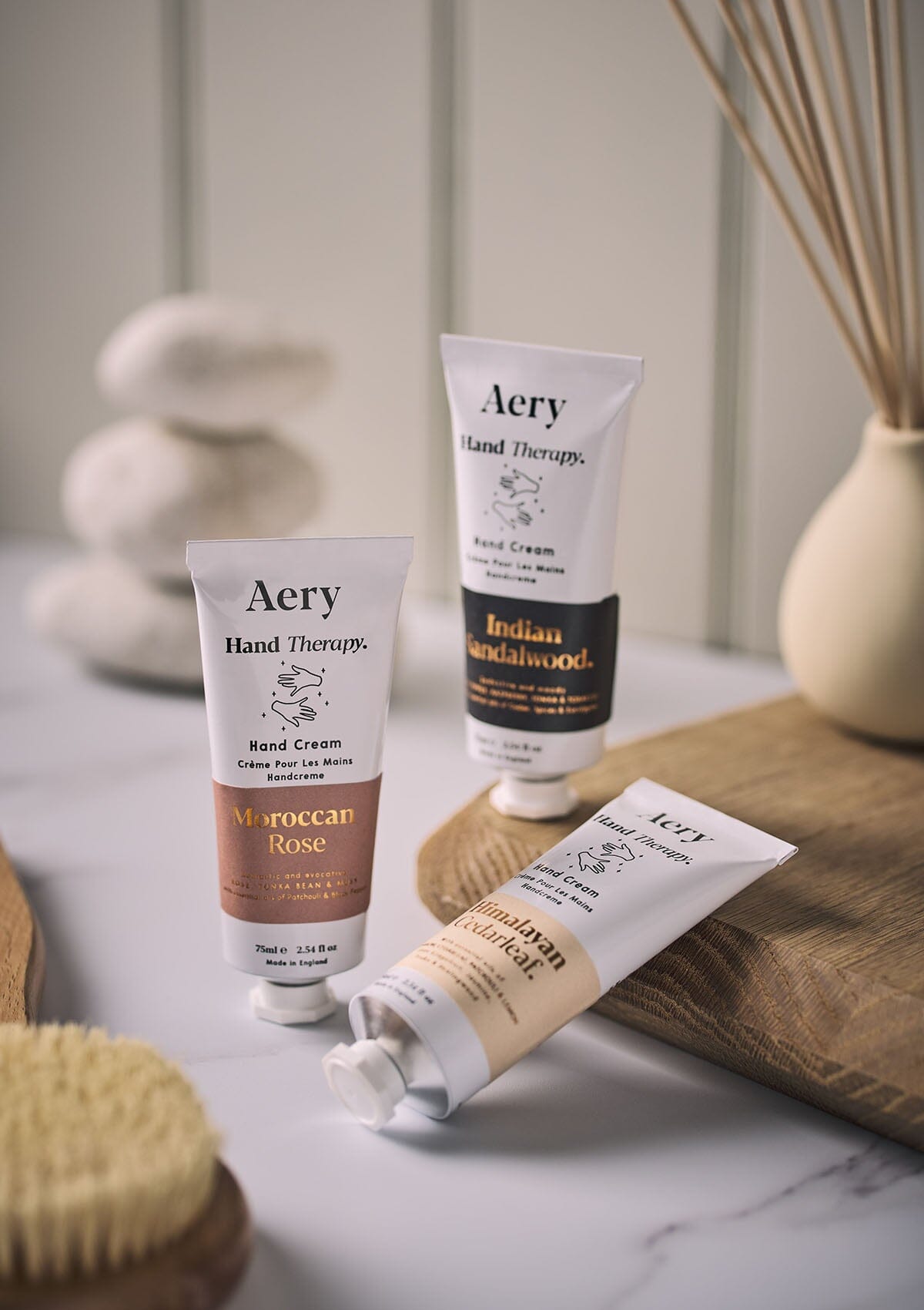 Himalayan Cedarleaf hand cream by Aery displayed next to Moroccan Rose hand cream placed in bathroom