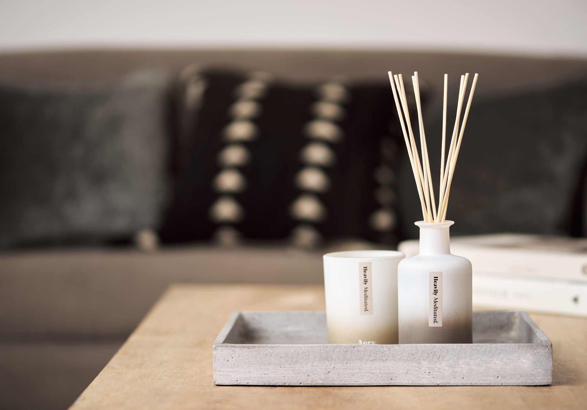 aery living heavily meditated reed diffuser and matching candle in decorative display tray on a coffee table