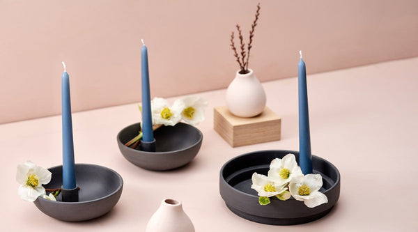 aery ceramic candle holders with blue candles and white flowers
