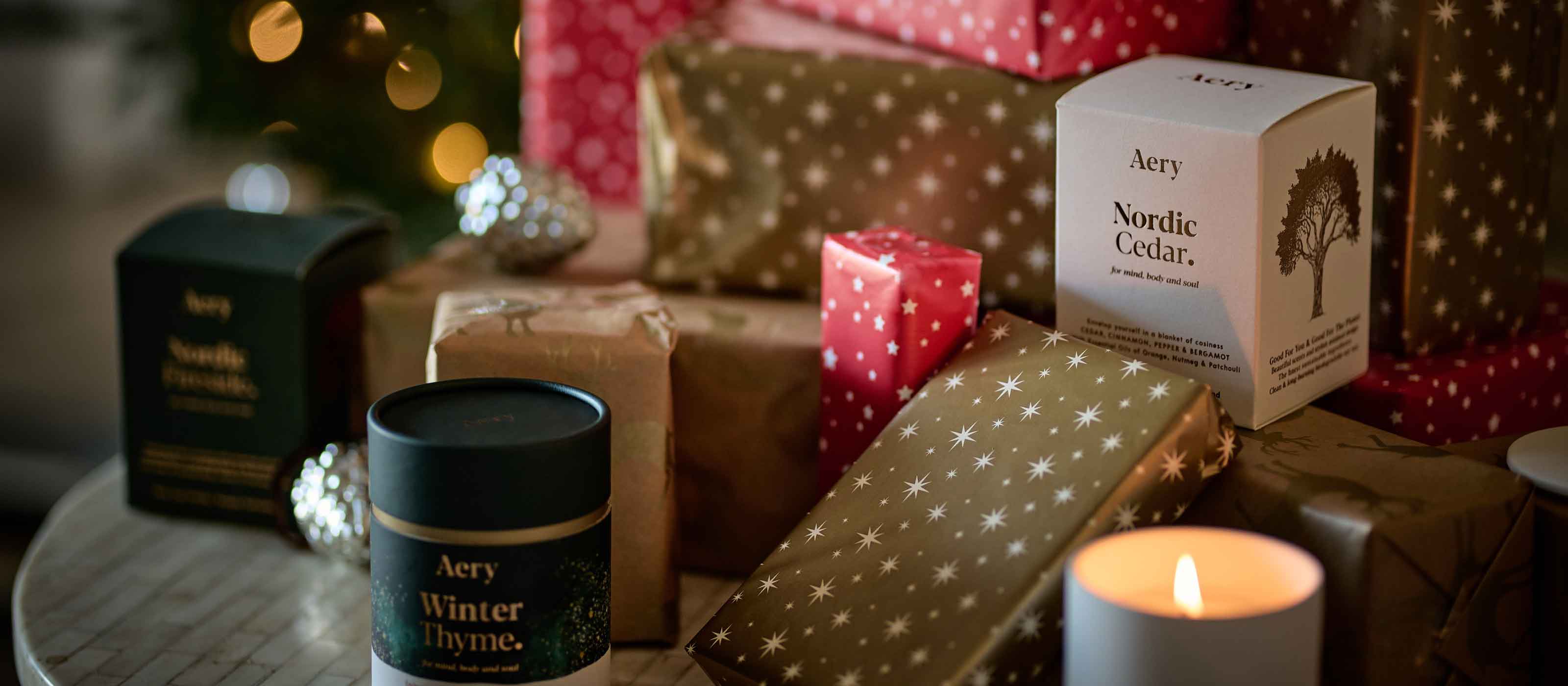 collection of aery candles and gift wrap christmas presents
