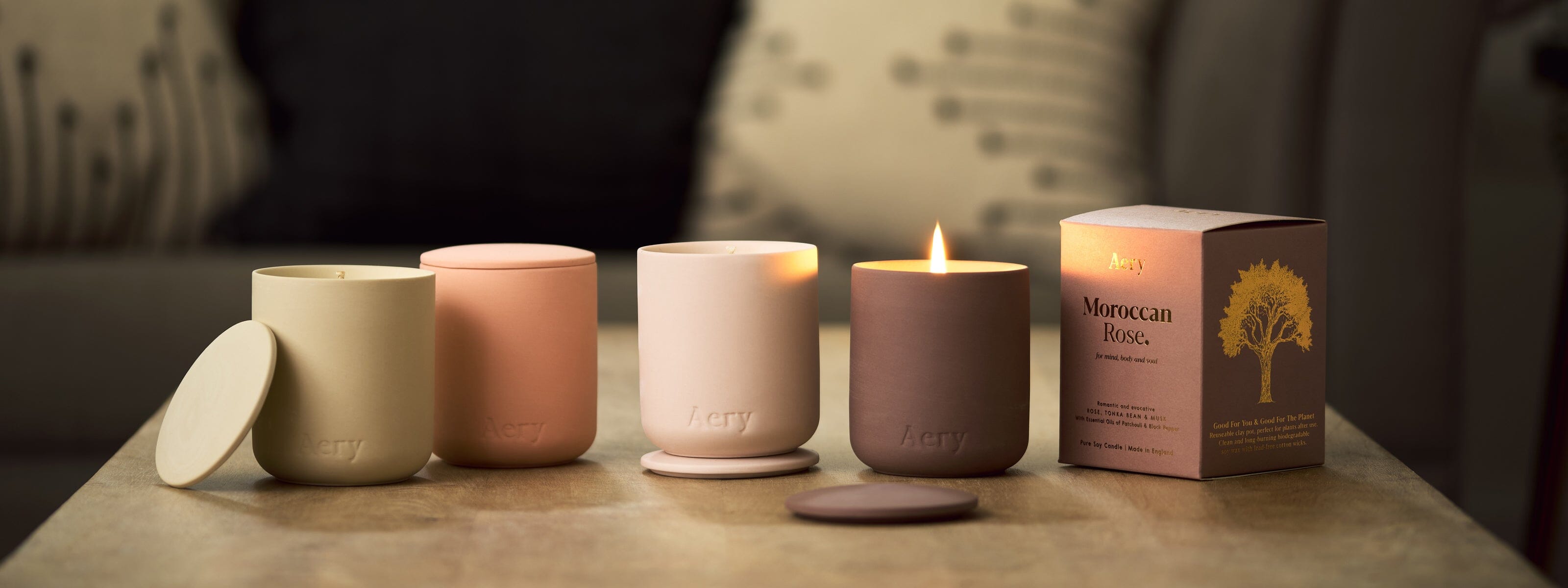 collection of ceramic aery living scented candles displayed decoratively on a coffee table