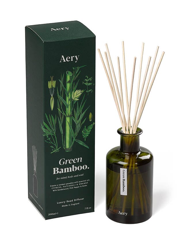 Green Bamboo diffuser by aery displayed next to product packaging on white background 