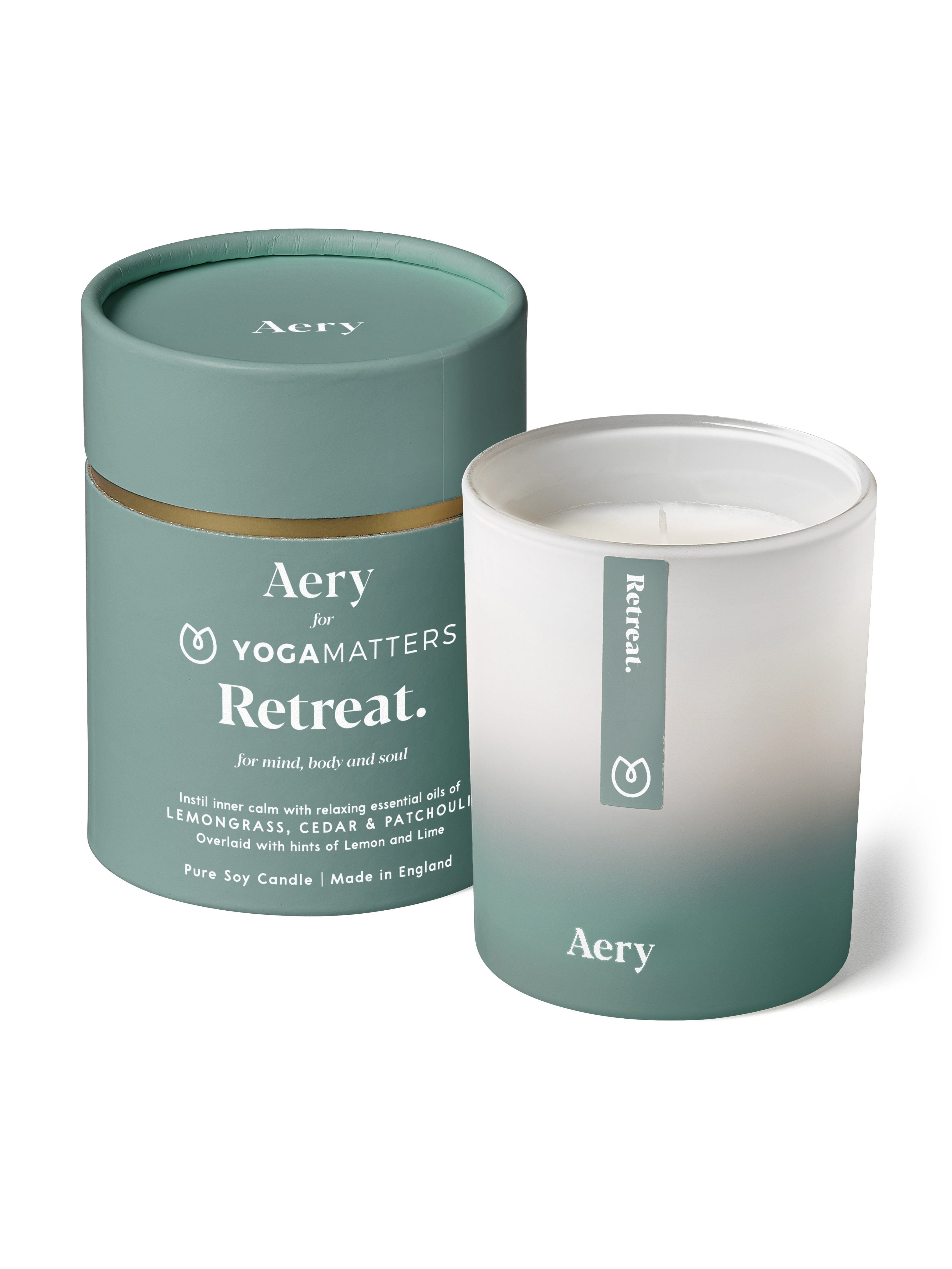 Blue Retreat candle by aery displayed next to product packaging non-white background 