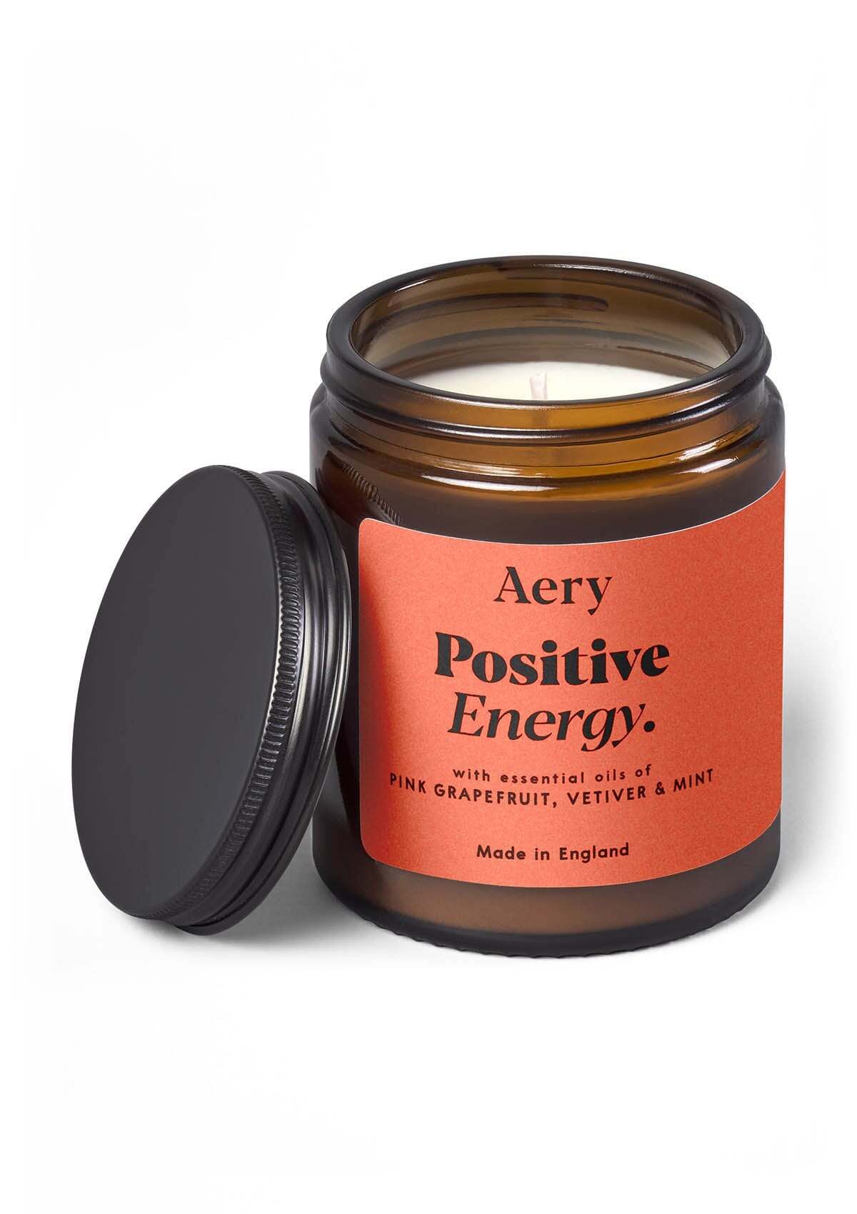 Orange Positive Energy candle by Aery on white background 