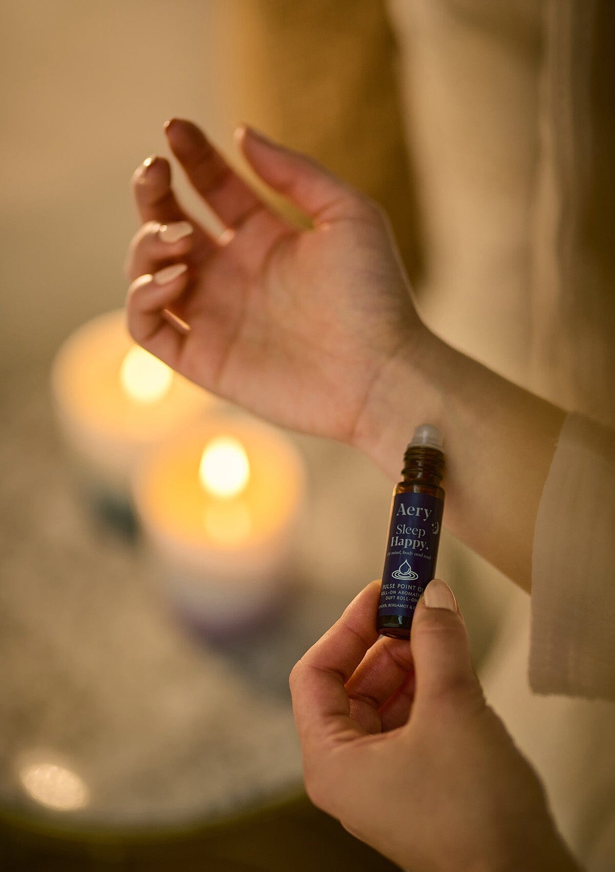 Blue Sleep Happy pulse point oil by Aery displayed in hands 