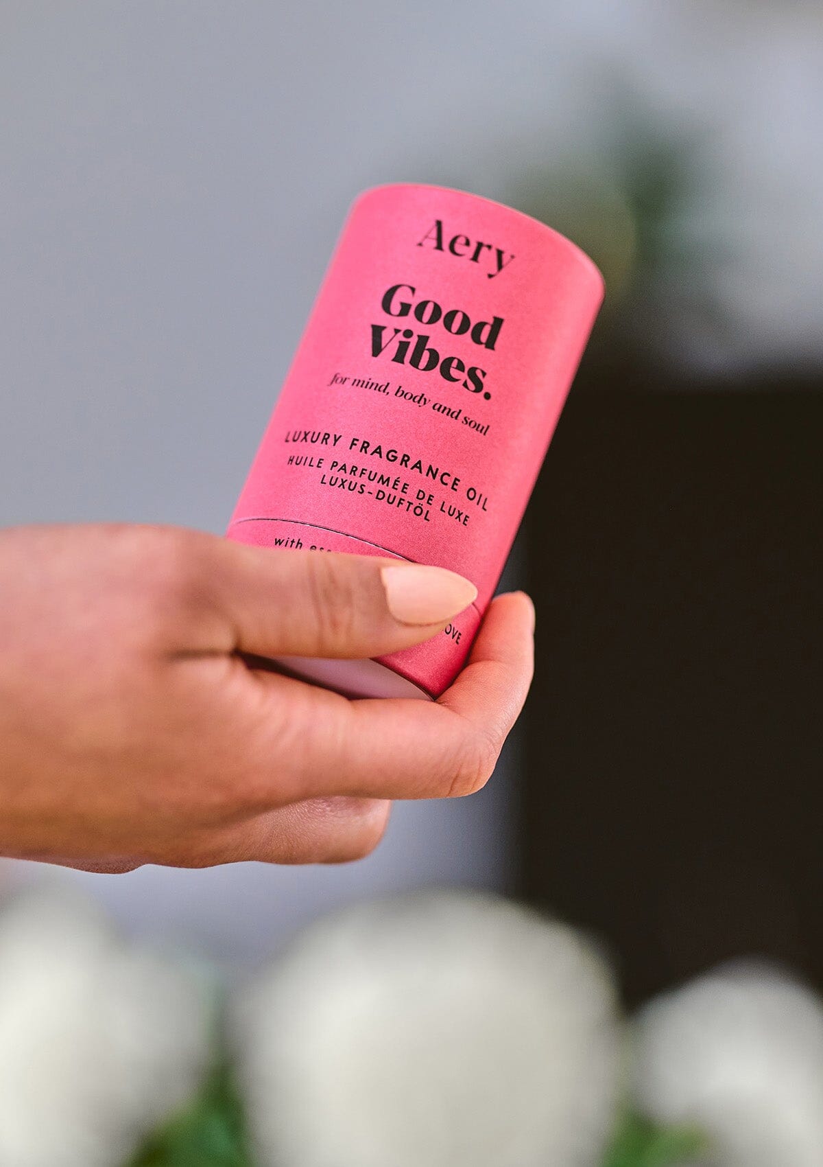 red Good Vibes fragrance oil by Aery displayed in hand 