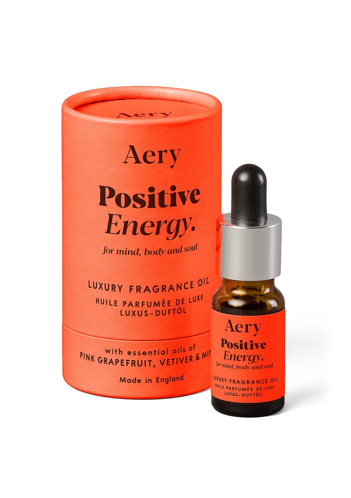Orange Positive Energy fragrance oil displayed next to product packaging by Aery on white background 