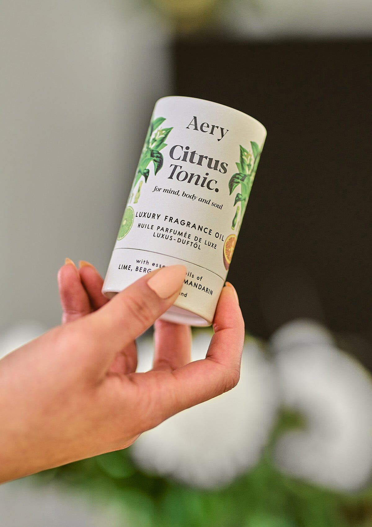 Citrus Tonic fragrance oil product packaging by Aery held in hand 