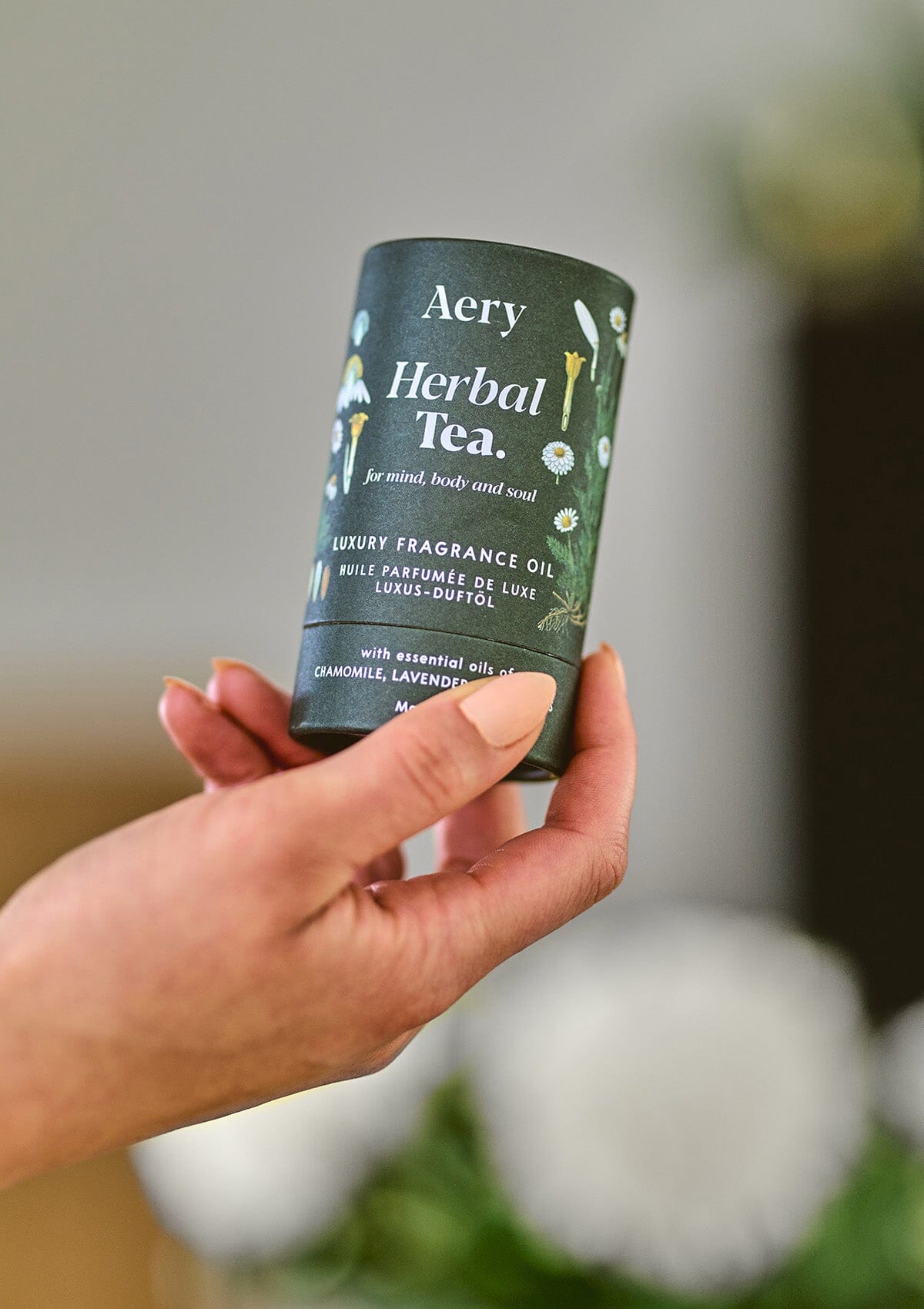 Green Herbal Tea fragrance oil product packaging by Aery displayed in hand 