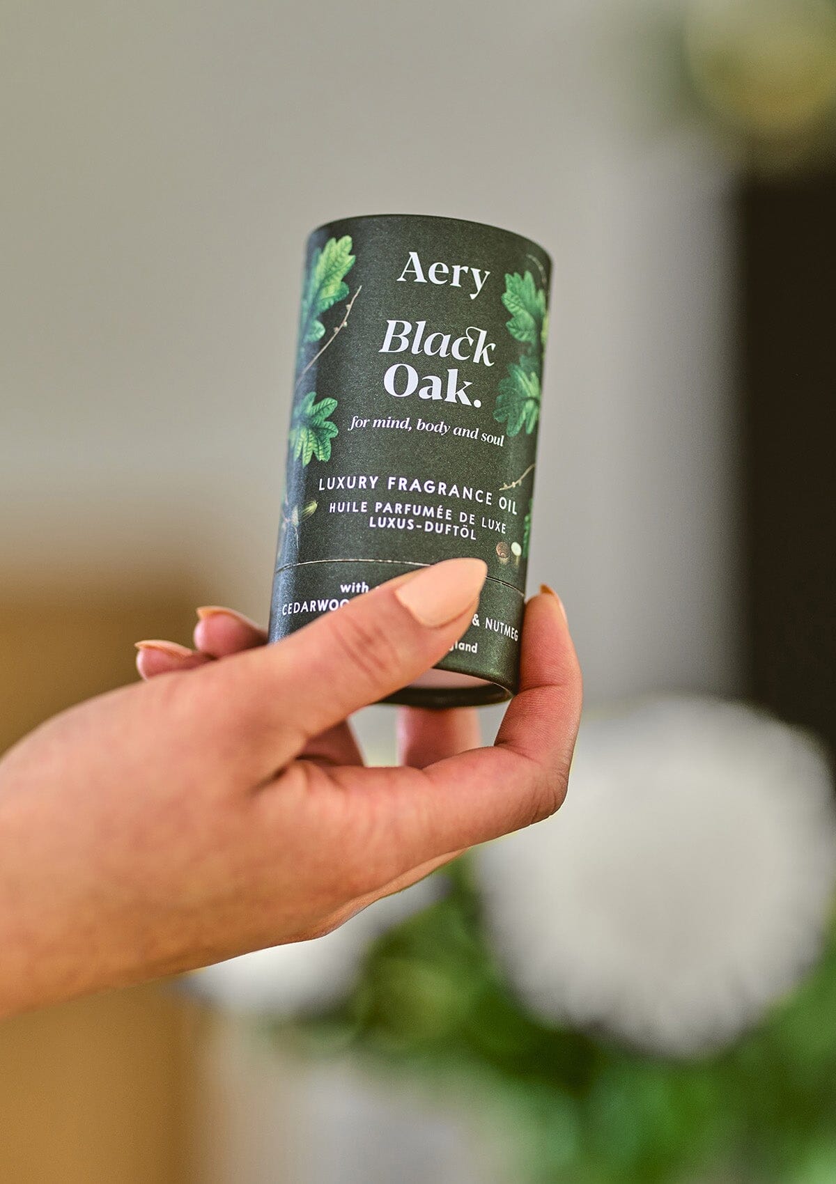 Green Black Oak fragrance oil product packaging by Aery displayed in hand 