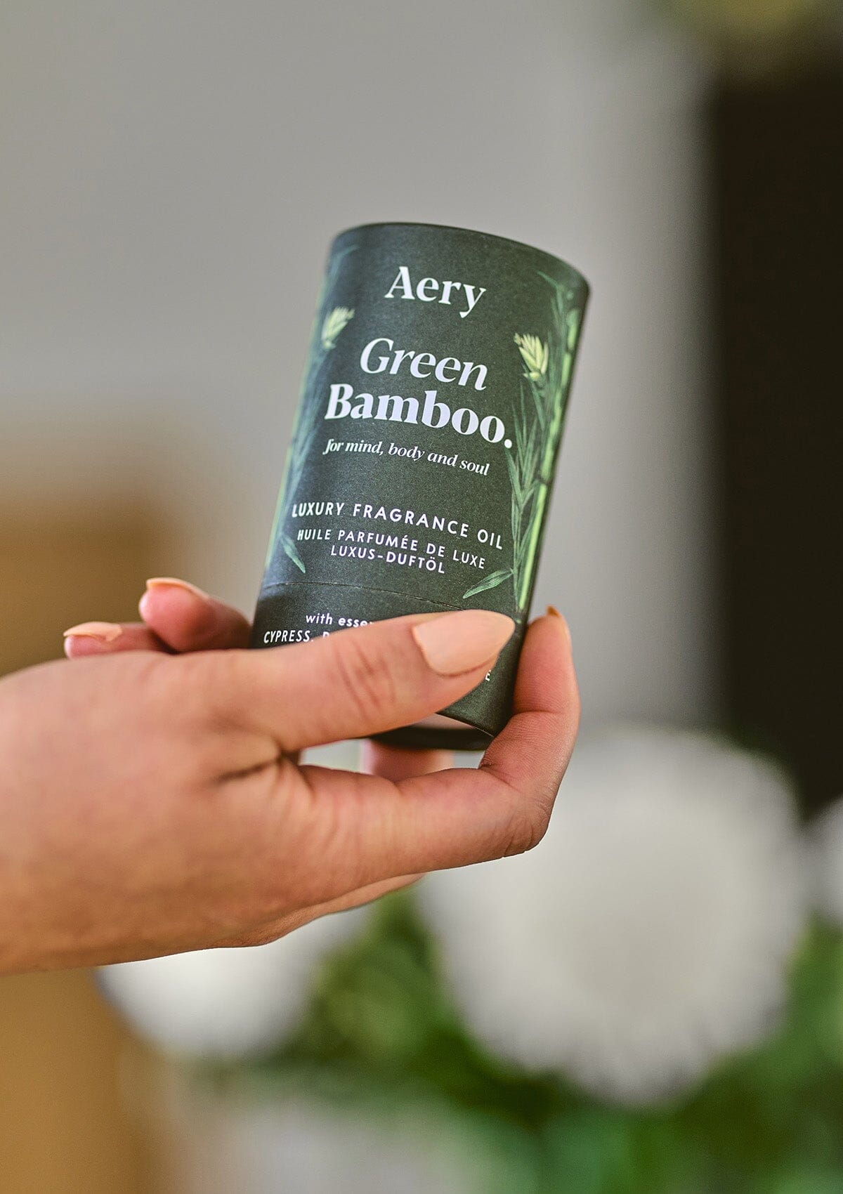 Green Bamboo fragrance oil  product packaging by Aery displayed in hand 