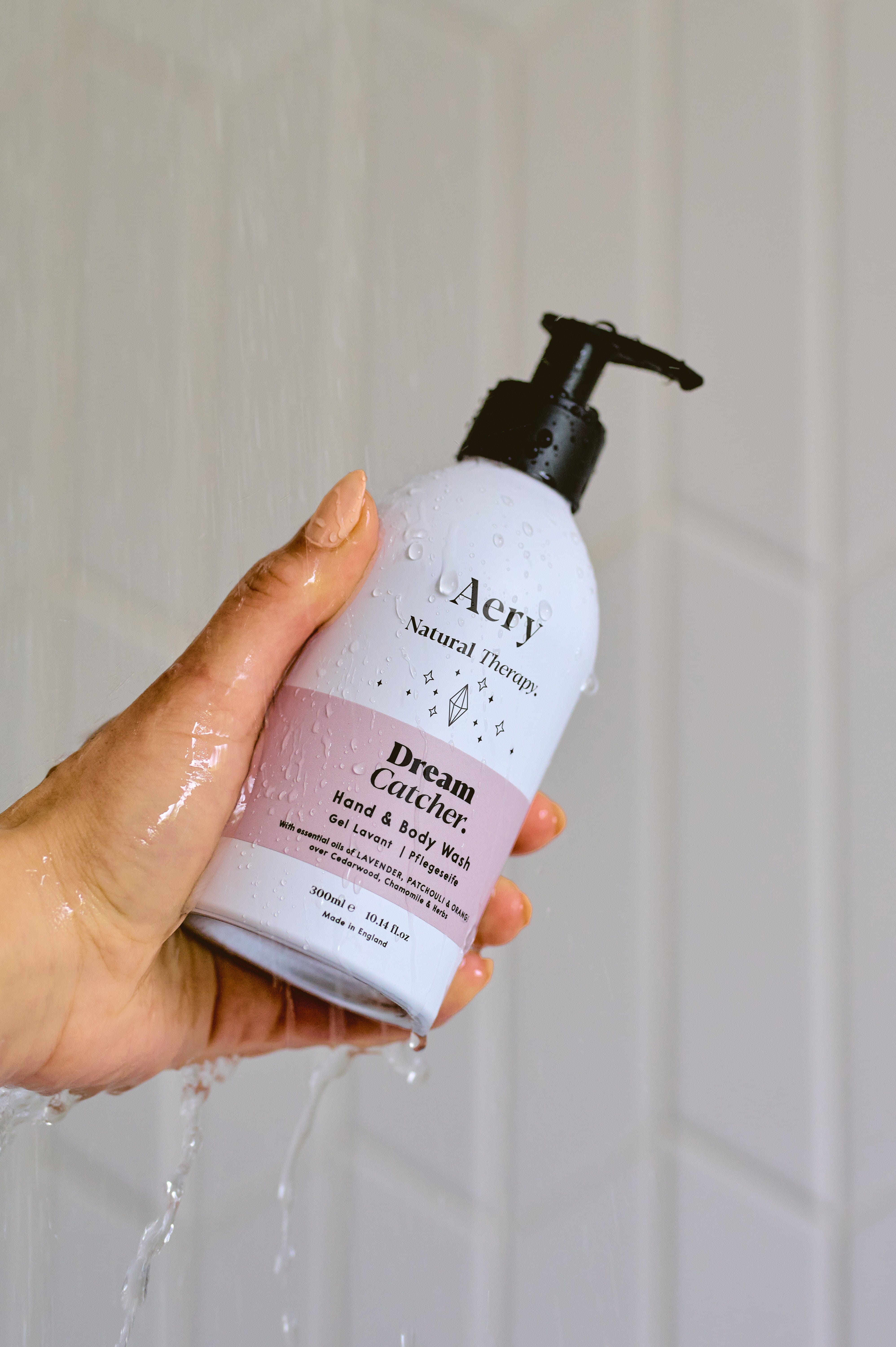 Lilac Dream Catcher hand wash by Aery displayed in hand in shower 