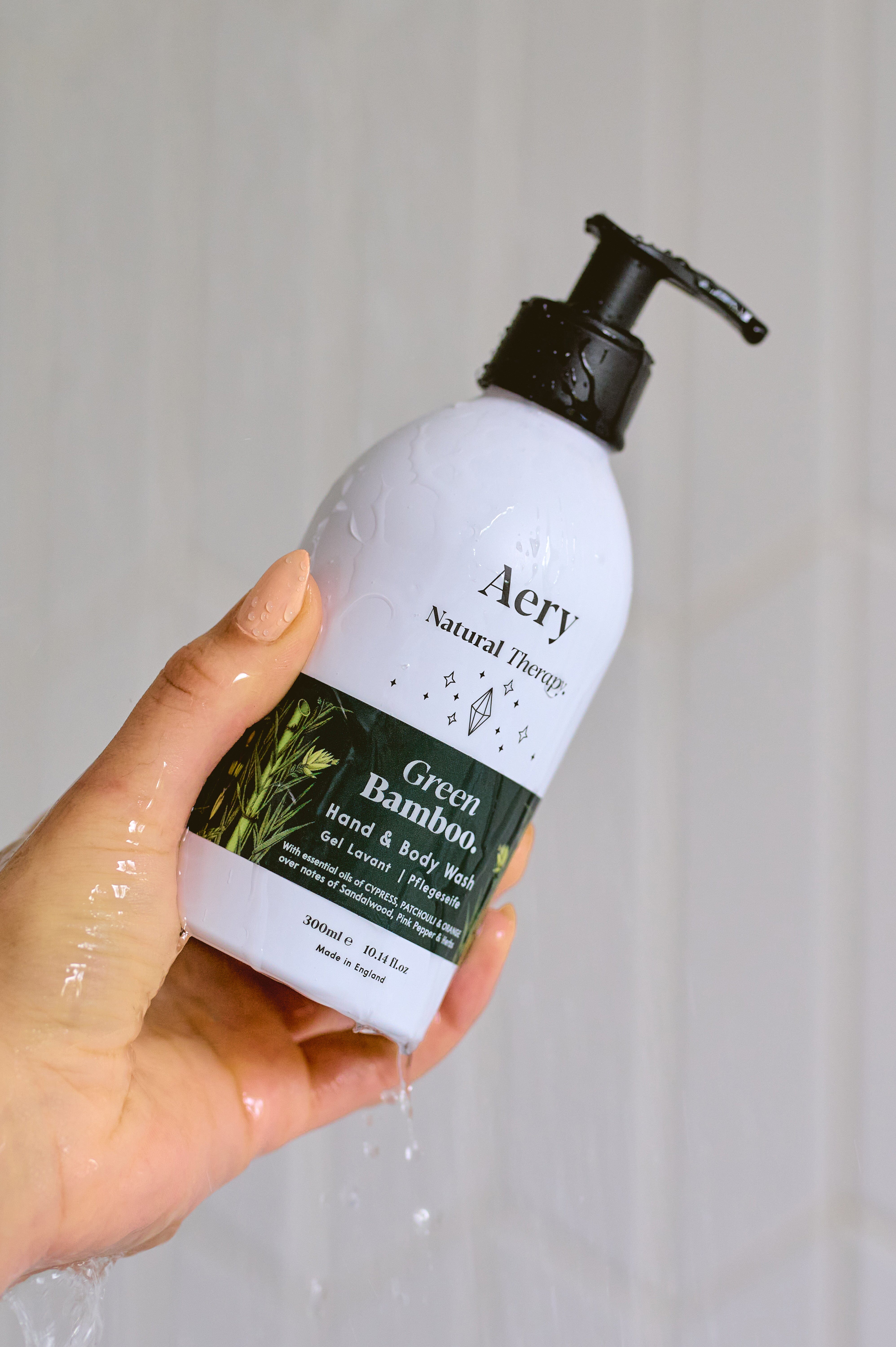 Green Bamboo Hand and body wash by Aery displayed in hand in shower 