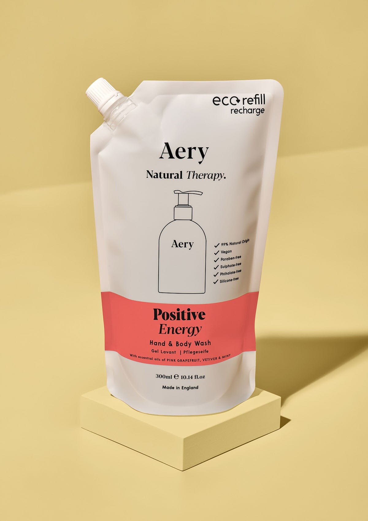 Red Positive Energy hand and body wash refill pouch by aery on yellow background 