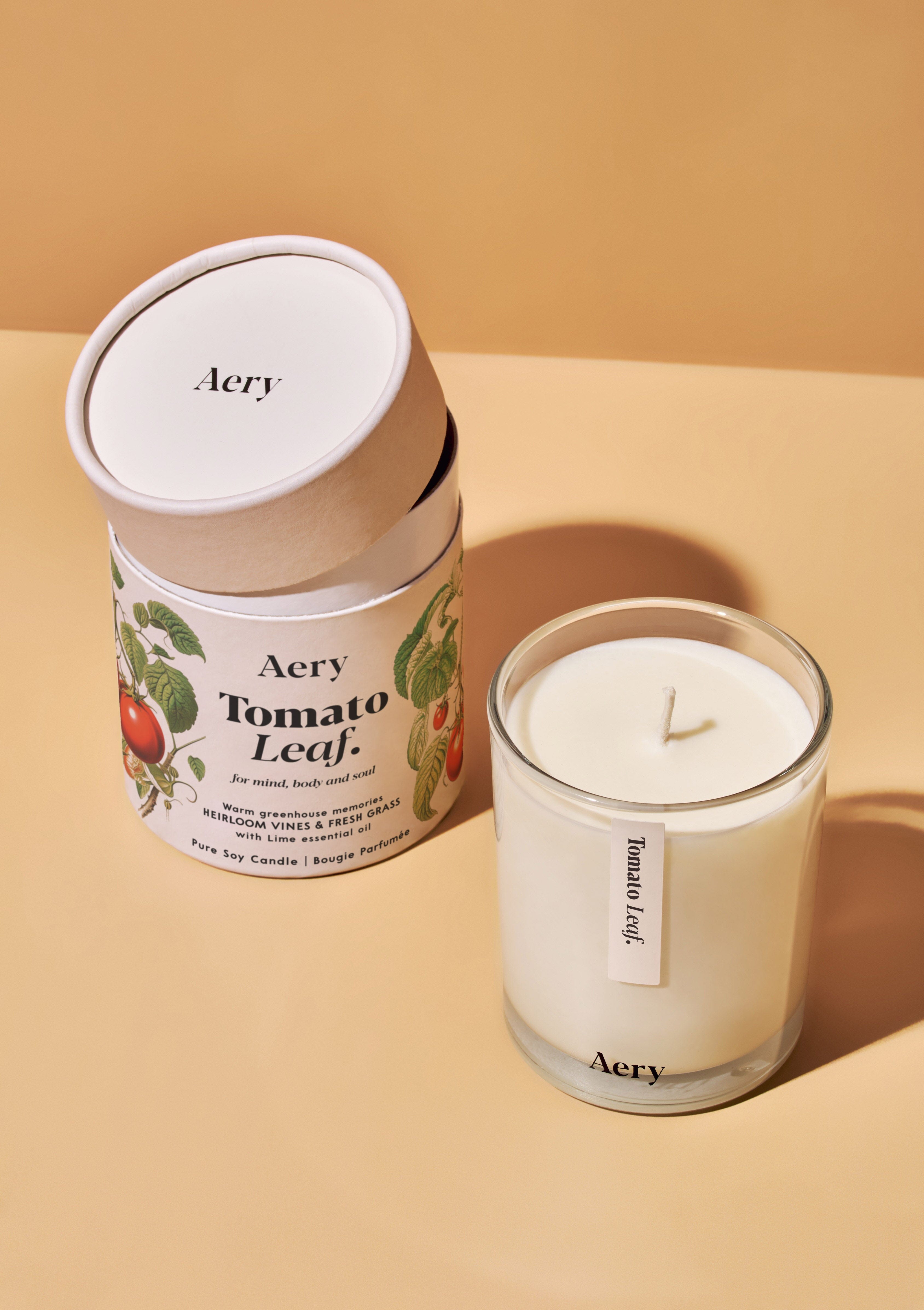 tomato leaf scented candle displayed next to decorative illustrated packaging