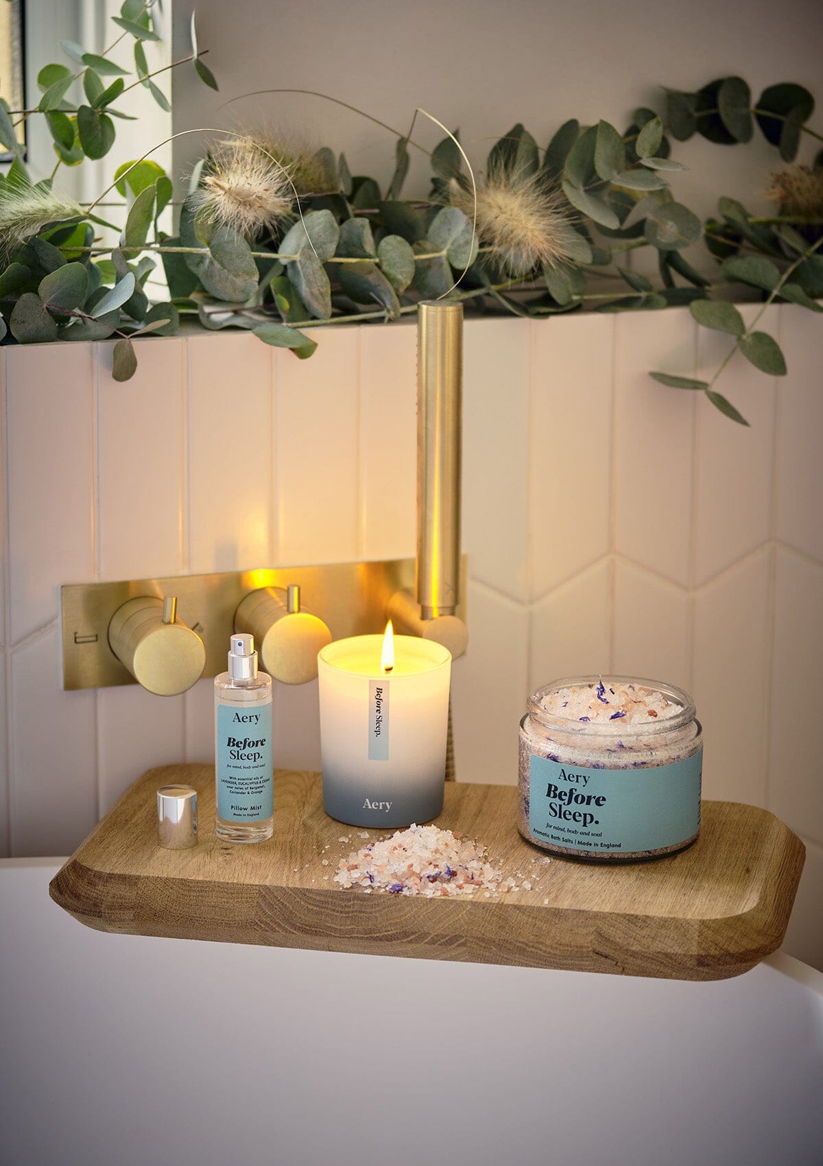 Blue Sleep Before bath salt displayed with Before Sleep pillow mist and candle by Aery placed on wooden tray in bathroom 