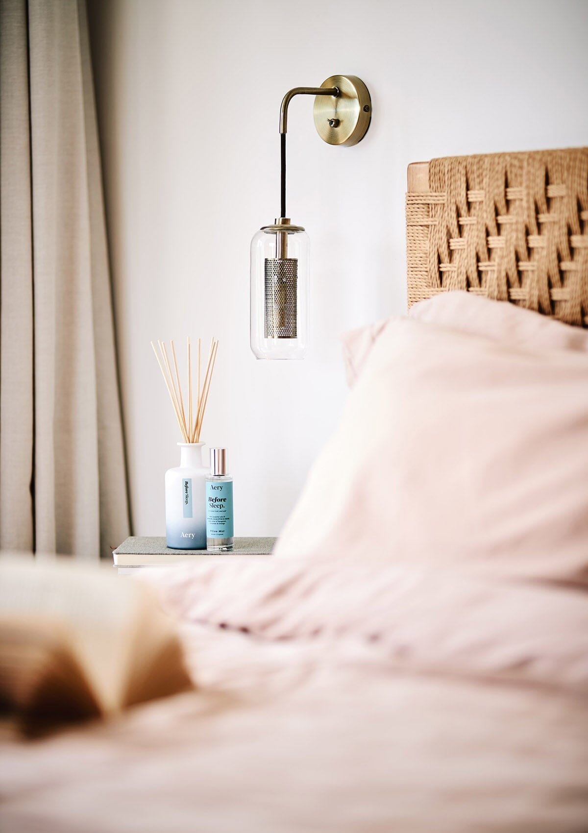 Blue Before Sleep Diffuser by Aery displayed with Before Sleep pillow mist placed in bedroom on bedside table 