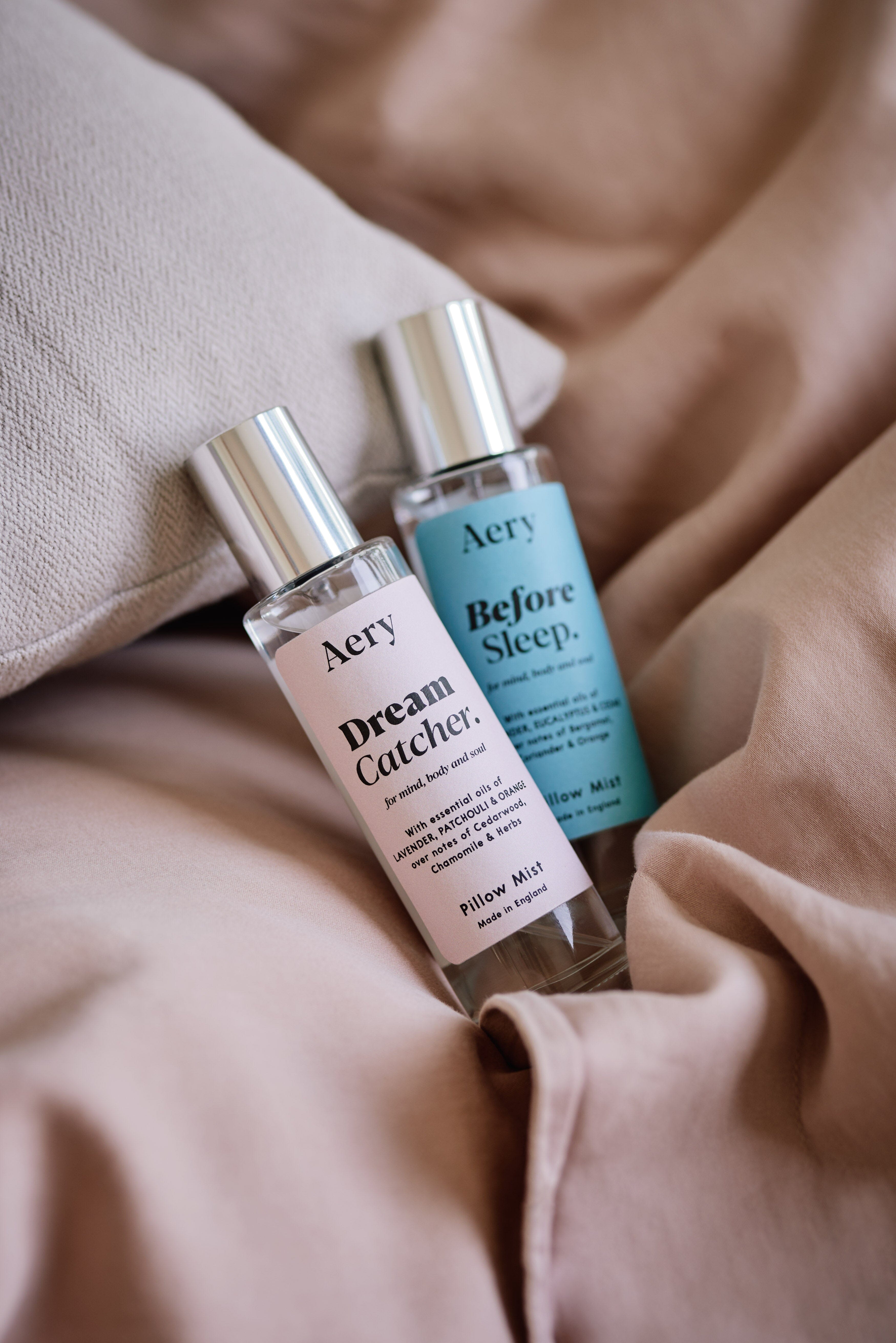 Blue Before Sleep pillow mist by Aery displayed next to Dream Catcher Pillow Mist on pink bed 