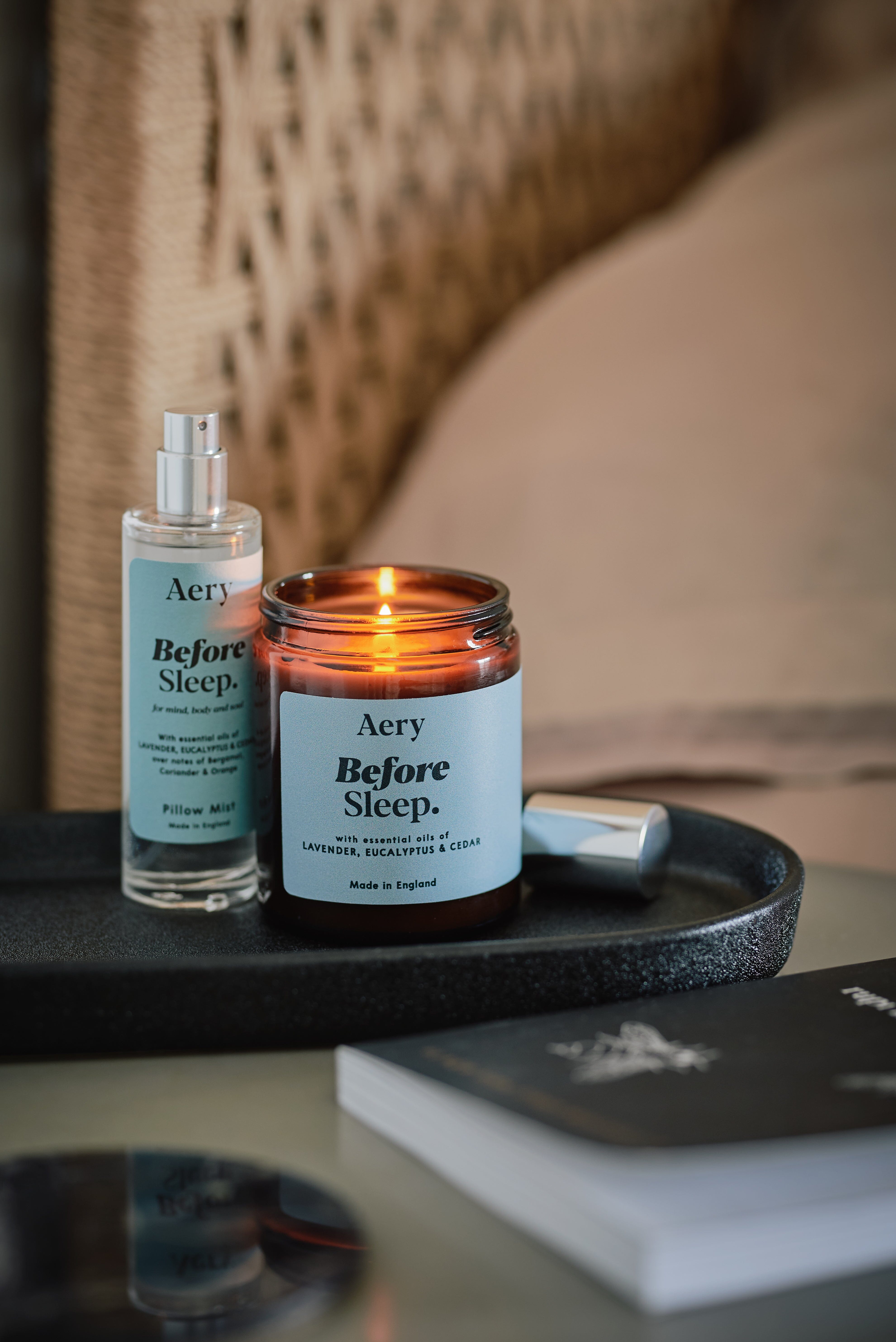 Blue Before Sleep jar candle by Aery displayed next to Before Sleep pillow mist on black tray place on bedside table 