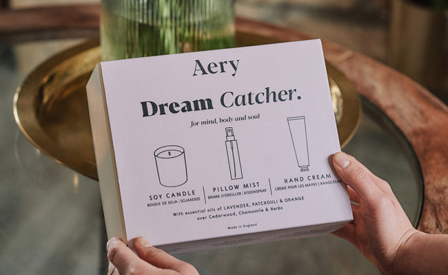 Aery living dream catcher gift set being held by a person on top of a coffee table