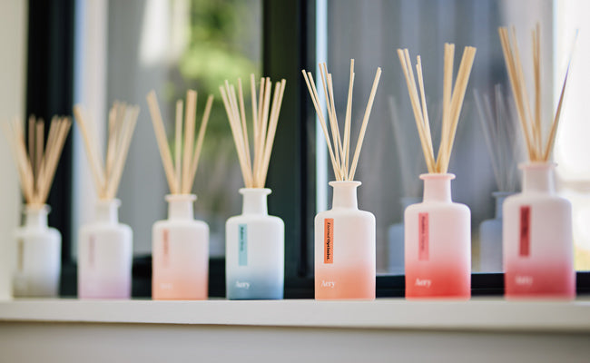 decoratively displayed window setting with rainbow coloured aery living diffusers