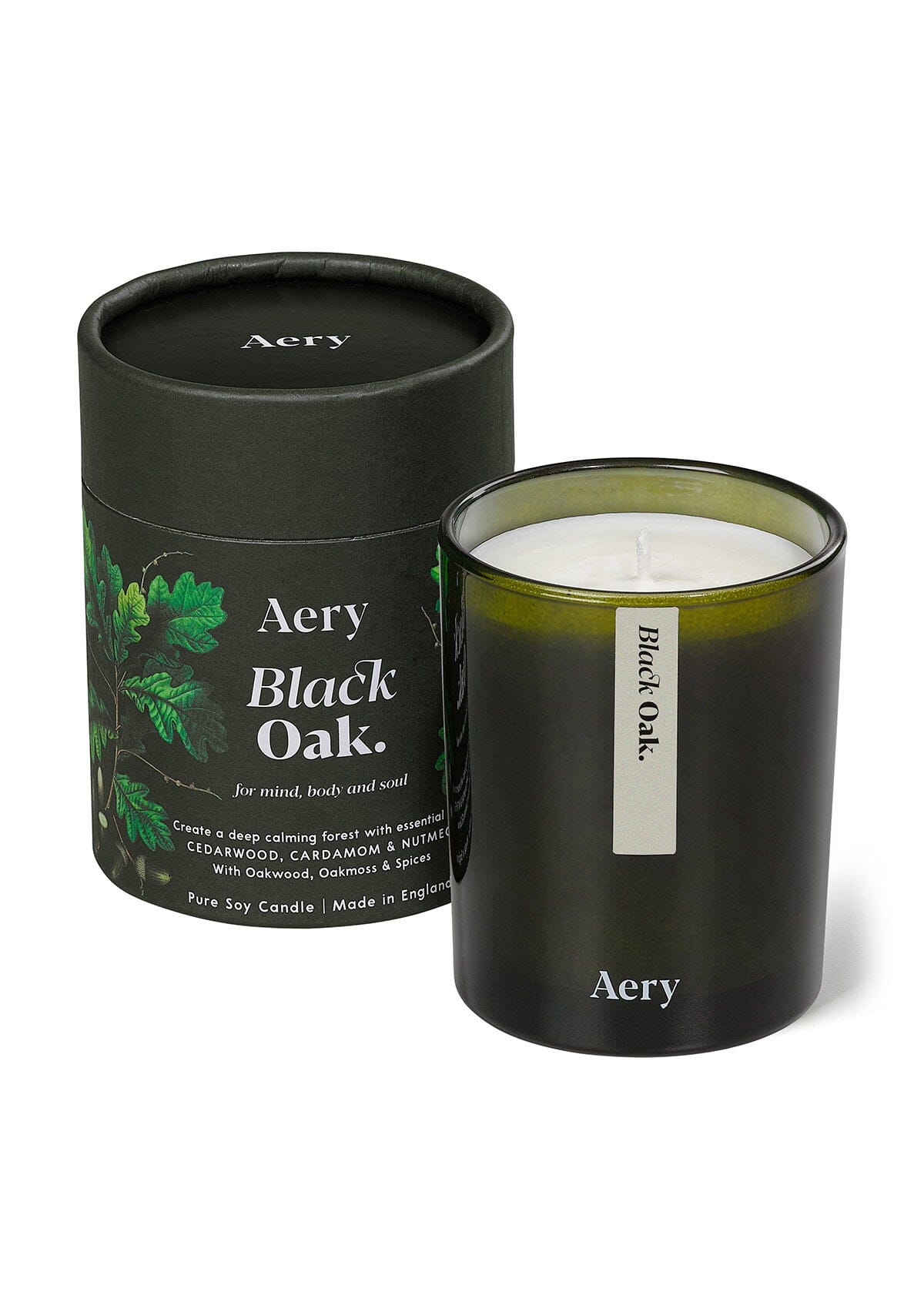 Green Black Oak glass scented candle displayed next to product packaging  on white background 