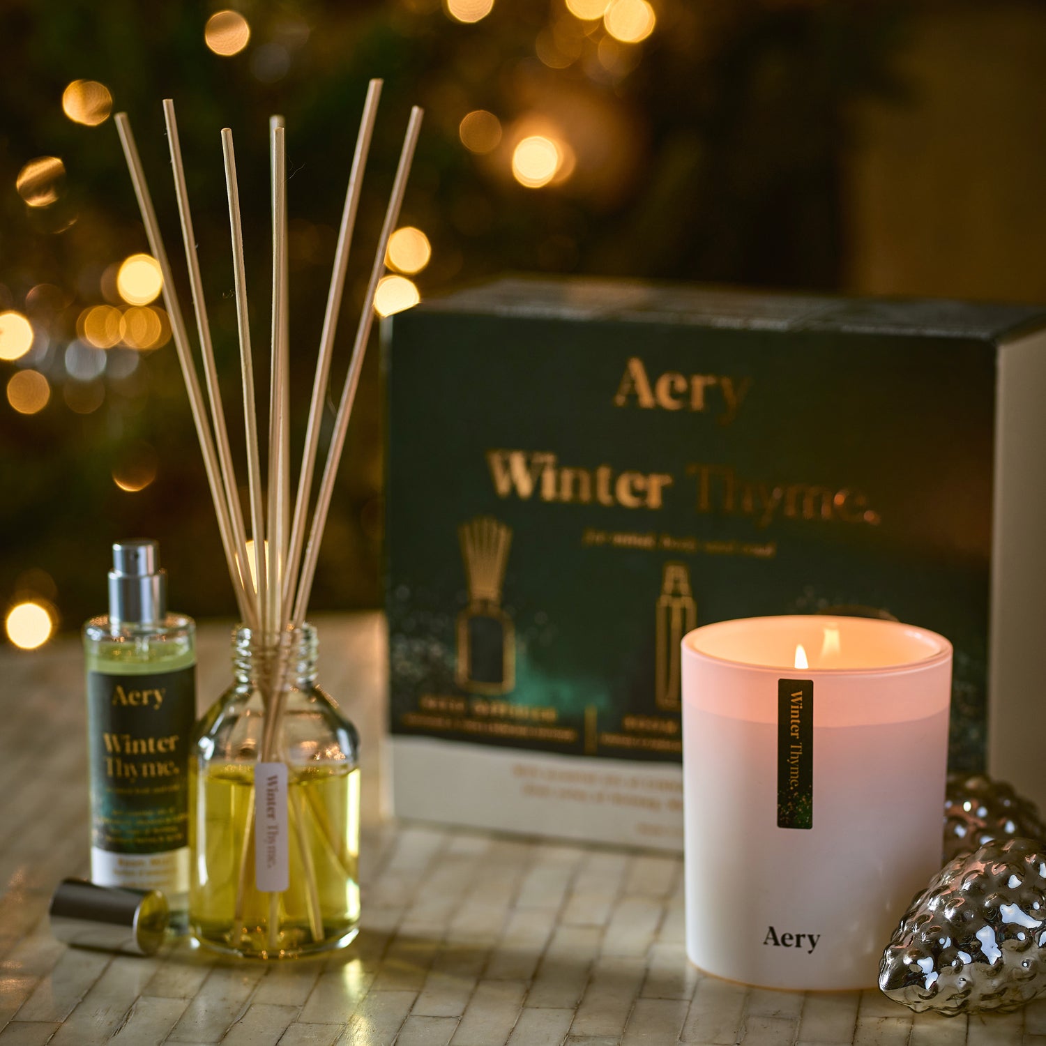 winter thyme gift set of candle reed diffuser and room mist displayed in christmas festive setting