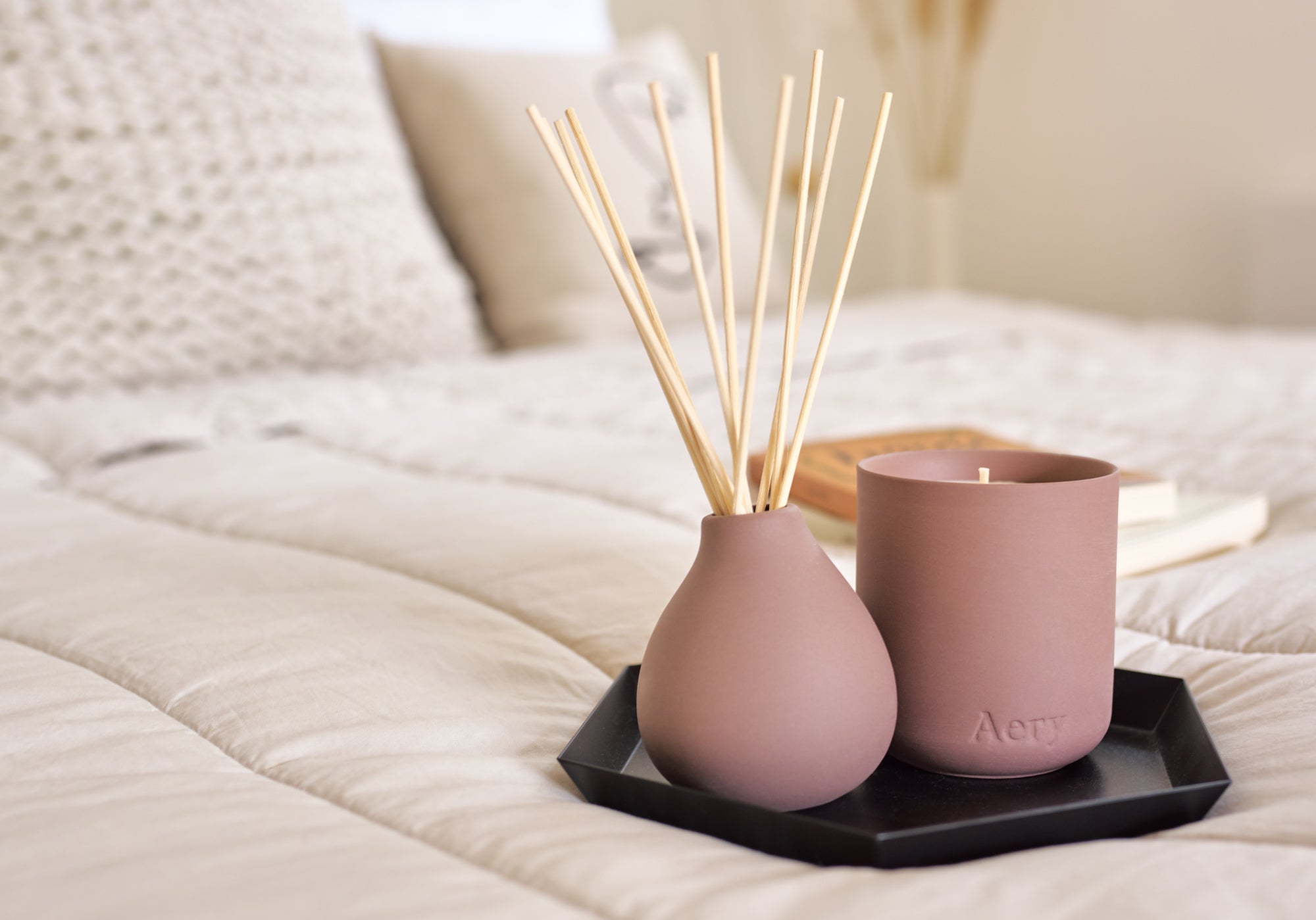 moroccan rose mauve ceramic scented candle and matching diffuser from Aery displayed in bedroom setting
