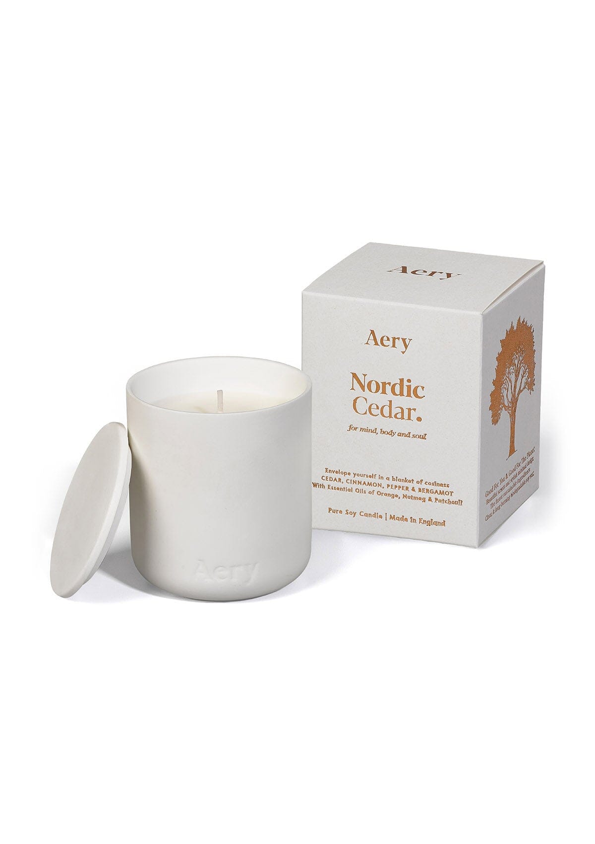 White Nordic Cedar ceramic scented candle displayed next to product packaging by Aery on white background 