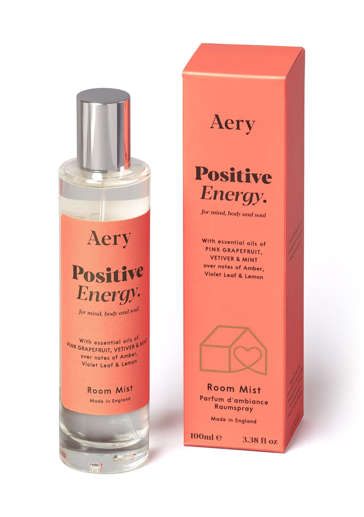 Orange Positive Energy room mist displayed next to product packaging on white background 