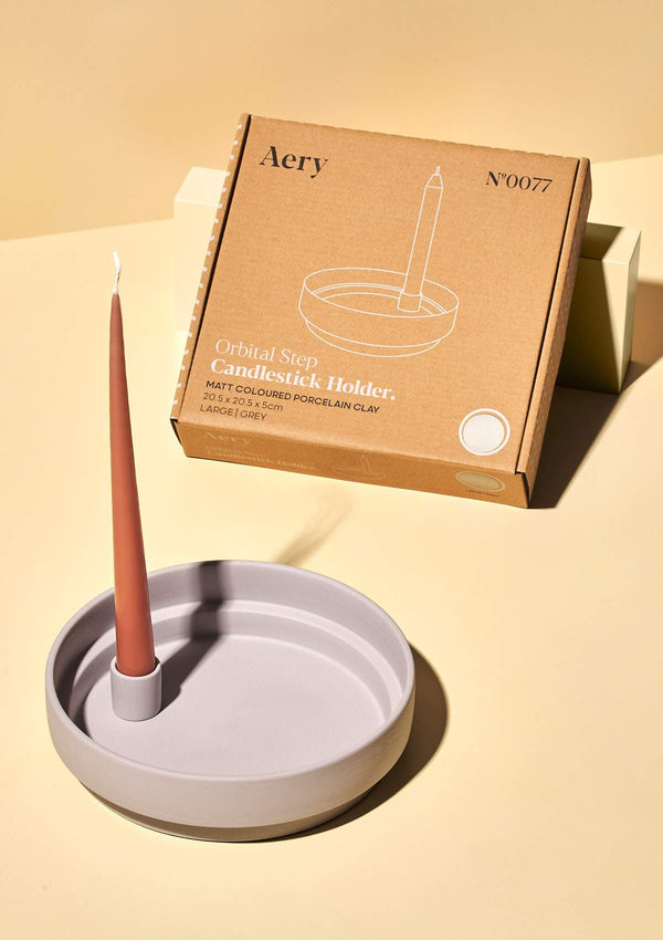 aery light grey ceramic candle holder with pink tapered candle and kraft box packaging