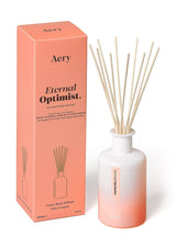 aery living eternal optimist reed diffuser bottle next to orange product packaging