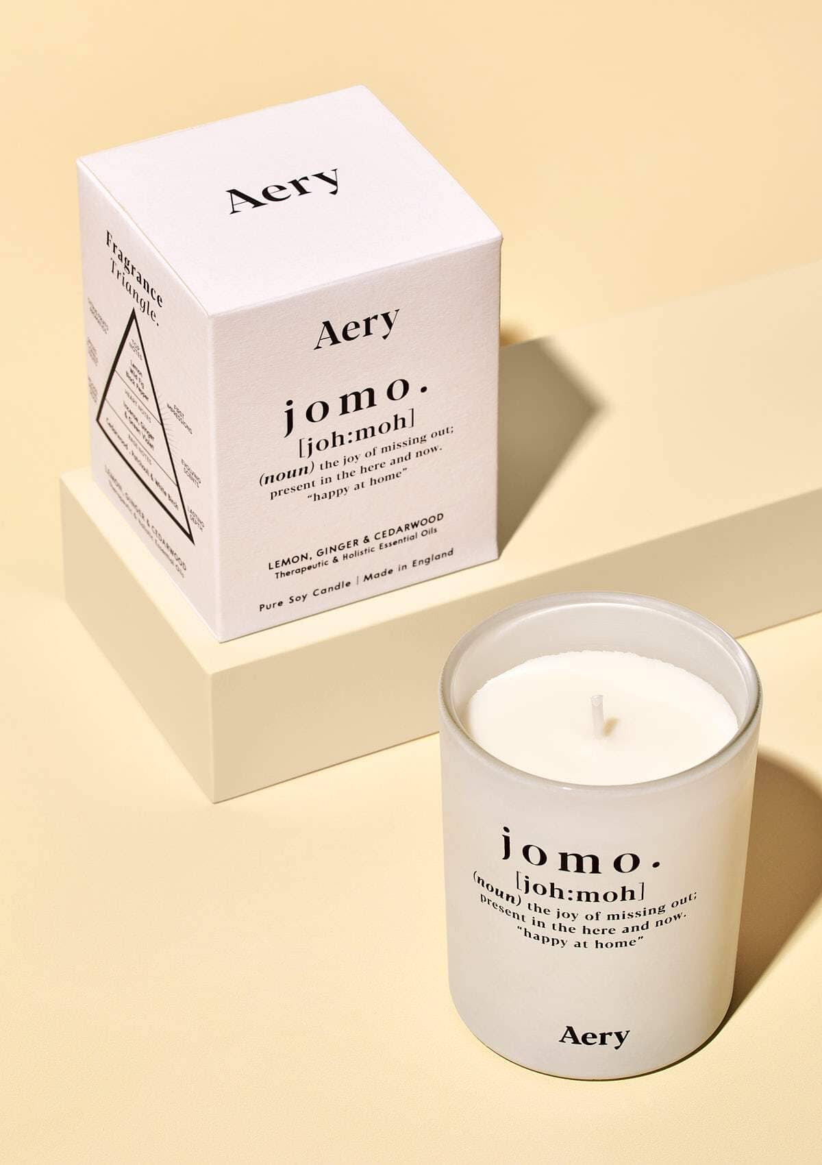 aery living jomo candle displayed next to product packaging