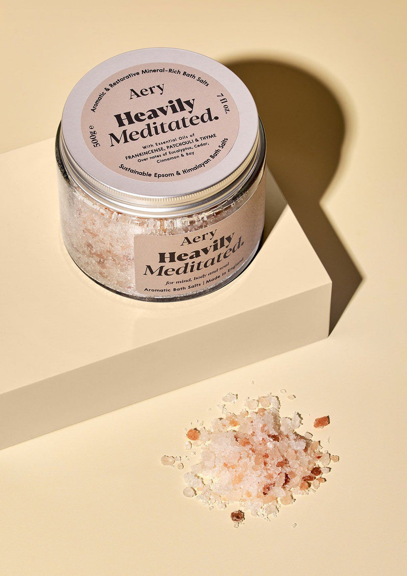 aery living heavily meditated bath salts in glass jar with salts decoratively sprinkled in front