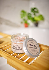 Aery Living Heavily Meditated bath salts with lid off on bath tray in bathroom setting