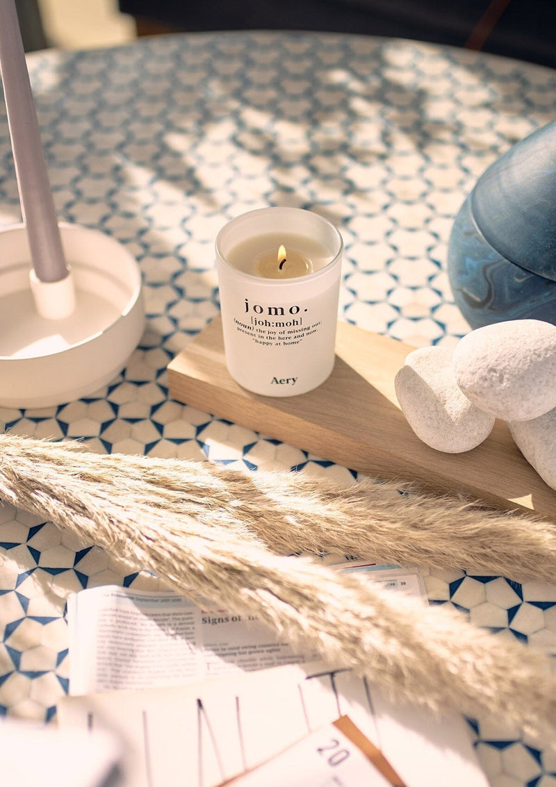 kitchen table setting with decorative centre piece and lit jomo candle