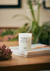 coffee table with jomo candle and wisp of smoke 