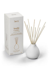 aery living white ceramic reed diffuser next to white product packaging
